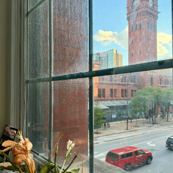 Dearborn Station clock tower through a window